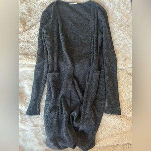 Long gray cardigan. Super cute with a black dress and some boots.